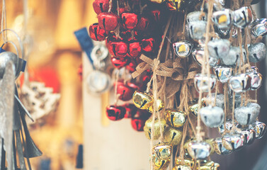Christmas tree decorations on Christmas market in european city . Fair and market stalls with craft Items. Winter street market in Europe.