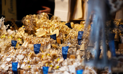 Christmas tree decorations on Christmas market in european city . Fair and market stalls with craft Items. Winter street market in Europe.