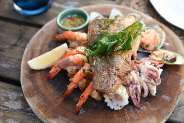 Close up view of delicious seafood platter on wood table 