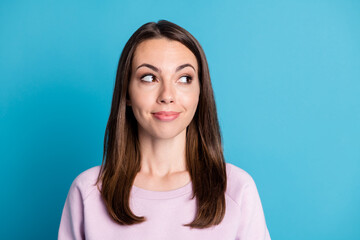 Fototapeta premium Photo of lovely charming young lady interested look side empty space smiling wonder how much cost dress if she use promo coupon wear violet pullover isolated blue color background