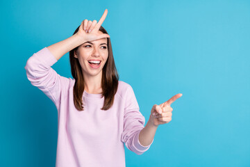 Portrait of her she nice attractive pretty rude cheerful cheery girl showing horn symbol having fun...