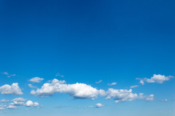 Bright blue sky with white clouds scattered on a natural background