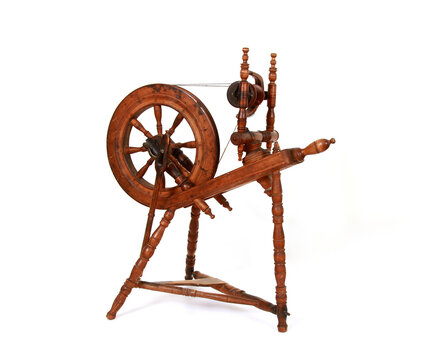 Vintage wooden spinning wheel isolated on a white background