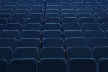 Obraz premium Blue empty seats in the hall are prepared for participants of mass events. Organization and holding of mass events, conferences or presentations