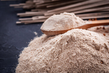 fresh natural buckwheat flour on a dark stone background culinary concept