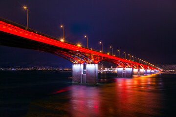 background bridge with illuminated river, at night