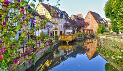 Fototapeta na wymiar View of half timbered houses with reflection on river in Colmar, France.