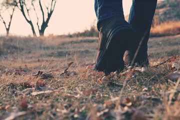 Legs of a man walking outdoors. Lifestyle fashion trendy style autumn season nature on background.