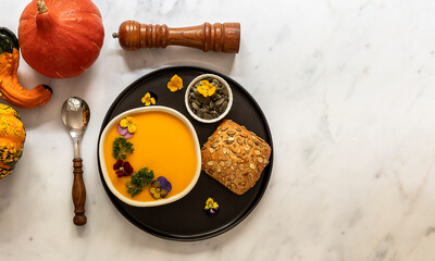 Bowl with seasonal pumpkin cream soup. Vegan recipe