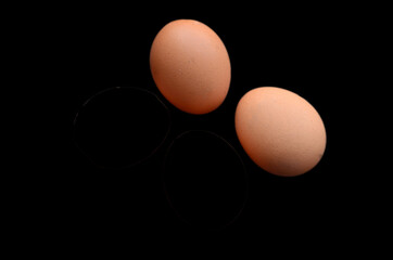 Chicken eggs on a black background. Ingredients for salad and various dishes.