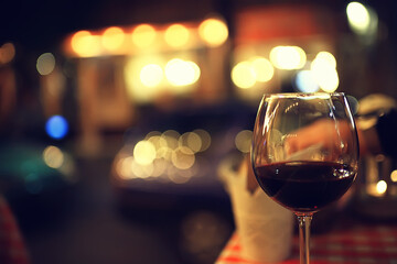 abstract aperitif alcohol glass in a restaurant interior, red wine background