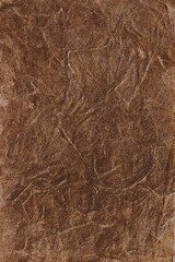Fototapeta na wymiar Textured handmade brown textile background with mesh and paper base. Vertical background handmade for design