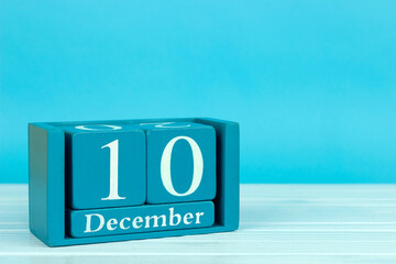 wooden calendar with the date of December 10 on a blue wooden background, International Animal Rights Day; World football day