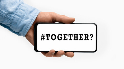 Closeup of a male hand holding Smartphone with word TOGETHER on display