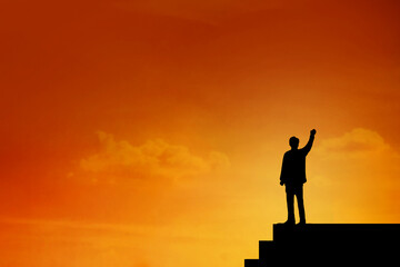 Fototapeta premium Silhouette of Businessman stand on the top of stairs , archievement , success and leadership concept.