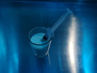 Medicine tube in a medicine glass on the table