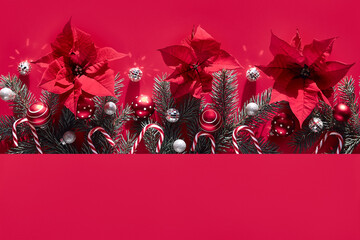 Seamless monochrome Christmas background in red and silver with fir twigs, poinsettia, decorations