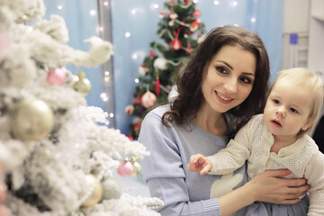 New Years Eve. The house is decorated for the holiday. Christmas tree with a garland and a family with gifts and a surprise.