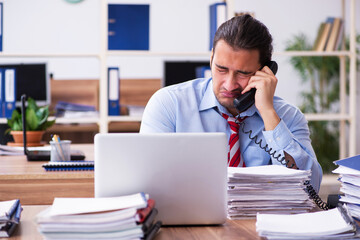 Young male employee unhappy with excessive work