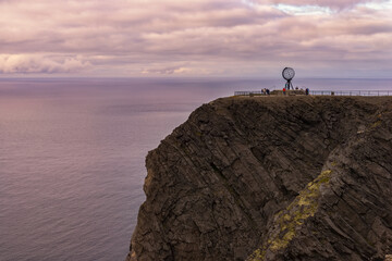 North Cape cliff at dusk, Norway.  North Cape Nordkapp is a cape on the northern coast of the...