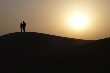 silhouette of a man walking on the beach