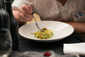 Irish colcannon served in a white bowl or traditional mashed potato with addition of kale, leek and green onion, close-up