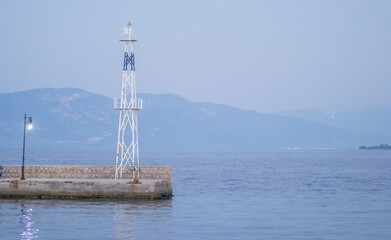Fototapeta na wymiar Lighthouse at the entrance to the port of Evia, Greece 