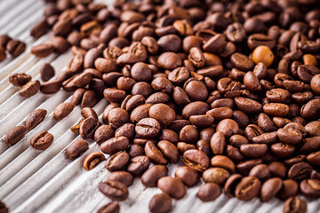 aromatic fresh coffee beans on a white wooden rustic background