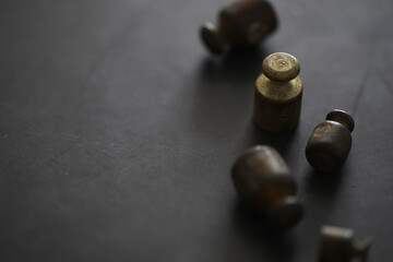 Tiny weights on vintage balance scales. Detail of Ancient old scale, Vintage old brass weight scale.