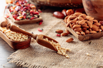 Pine nuts and dried fruits on a old wooden table.