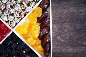 Nuts and dried fruits assortment on stone table top view.