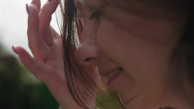 Side view of girl eating dewberry in bacl yard of house