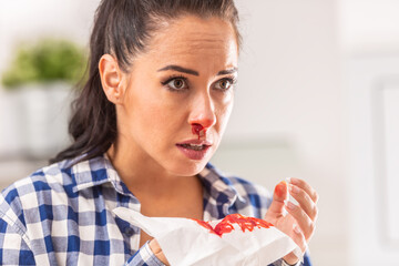 Woman find out her nose is bleeding after sneezing into a tissue