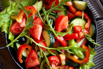 Fresh vegetable salad with tomatoes, arugula and other vegetables