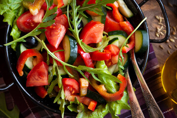Fresh vegetable salad with tomatoes, arugula and other vegetables