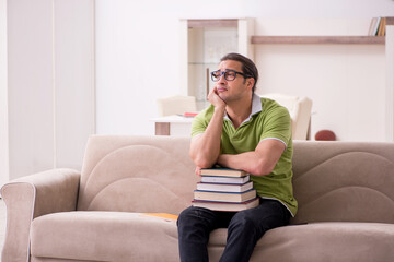 Young male student preparing for exams at home