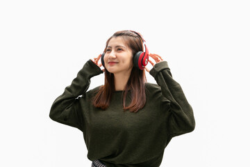 Young woman using phone for listening to music on white background.