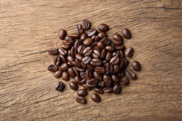 Flat lay (top view) of Roasted coffee beans on wood background.
