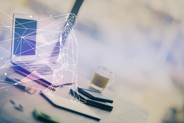 Desktop computer background in office and start up theme hologram drawing. Double exposure. Startup...
