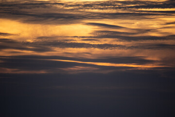 Sunset sky with clouds and orange and blue tones