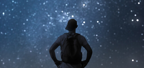 Man admires the mesmerizing night starry sky.