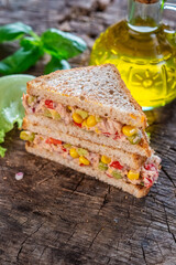 Healthy tuna sandwich with tomato, corn and onion 