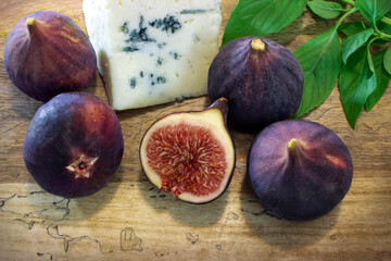 Figs and goat cheese on a white plate.