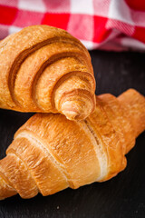 delicious fresh croissant on a white wooden rustic background