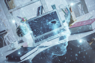 Double exposure of work space with computer and human brain drawing hologram. Brainstorm concept.