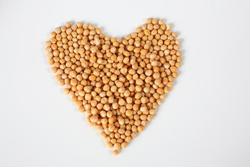 Heart-shaped peas on a white background
