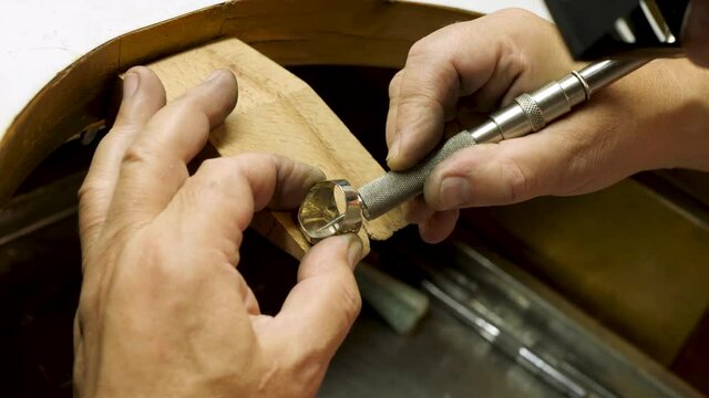 Jeweler Polishes A Silver Ring