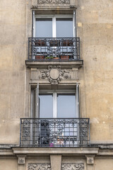 Old French house with traditional balconies and windows. Paris, France.