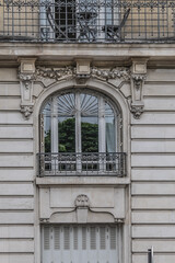 Old French house with traditional balconies and windows. Paris, France.
