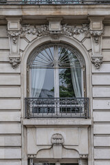 Old French house with traditional balconies and windows. Paris, France.